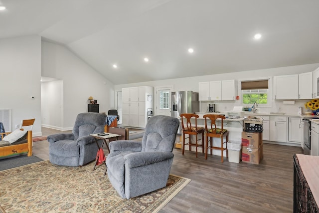 living room featuring sink, vaulted ceiling, and dark hardwood / wood-style floors