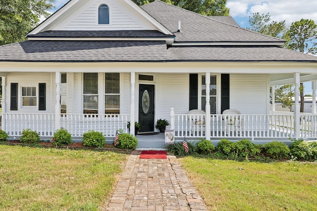 country-style home with a front yard and covered porch