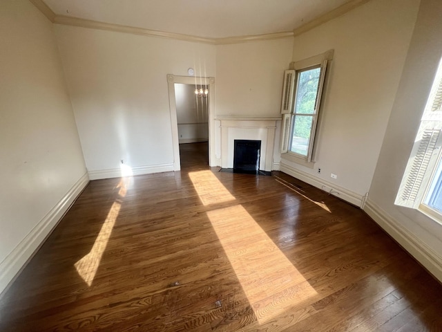 unfurnished living room with ornamental molding and dark hardwood / wood-style floors