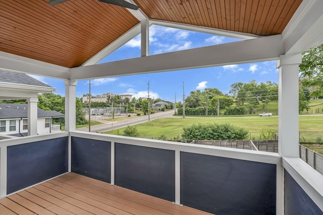 wooden terrace with a lawn