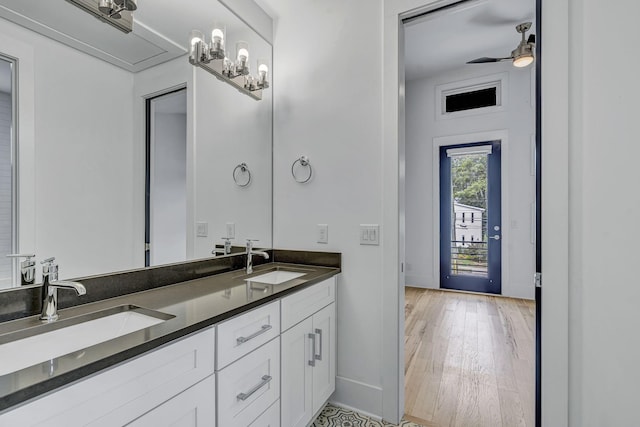 bathroom with ceiling fan, vanity, and wood-type flooring