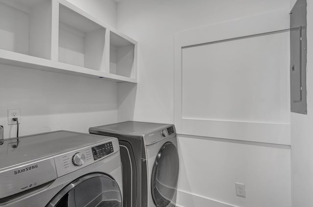 laundry area with washer and clothes dryer and electric panel