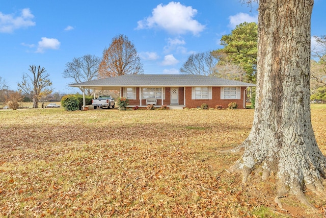 ranch-style house featuring a front yard and a carport