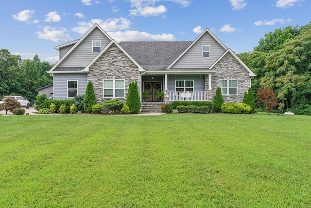 craftsman-style house featuring covered porch and a front lawn