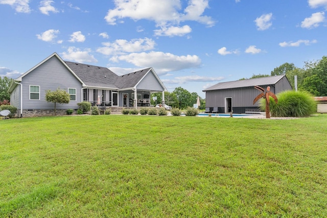 rear view of property featuring a yard