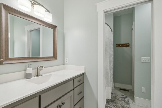 bathroom with vanity and tile patterned flooring