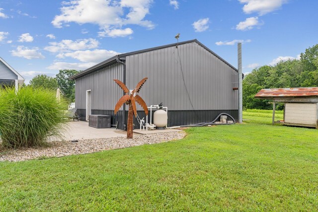 view of outbuilding featuring a lawn