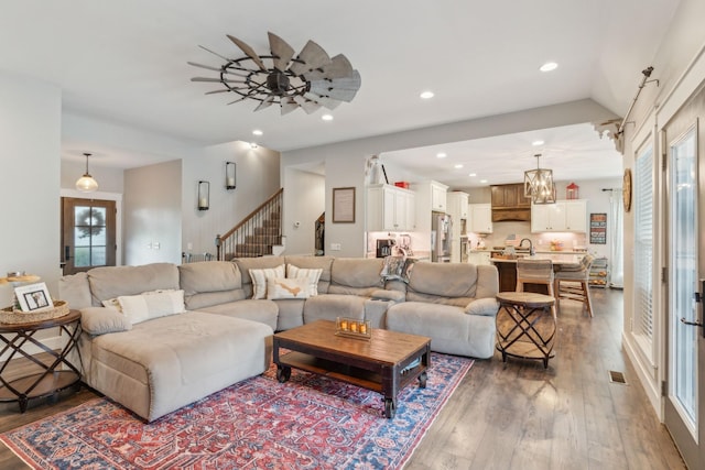 living room featuring sink, dark wood-type flooring, ceiling fan, and vaulted ceiling