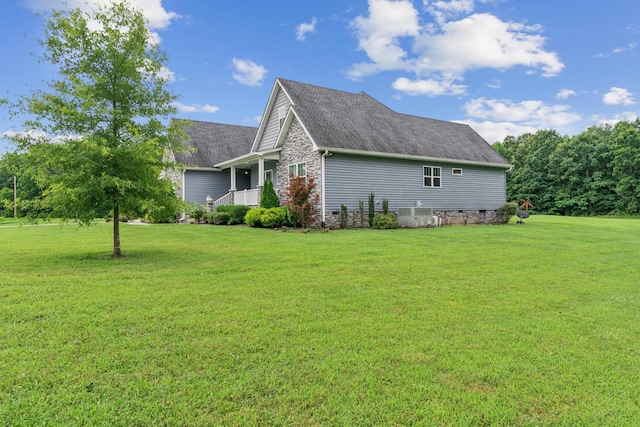 view of side of property with a lawn