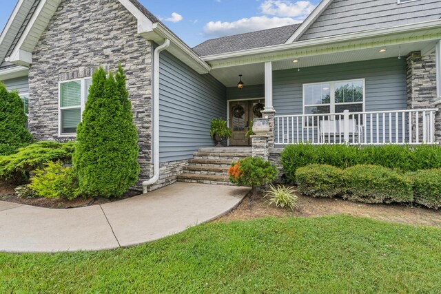 view of exterior entry featuring a porch