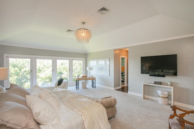 carpeted bedroom featuring a tray ceiling and vaulted ceiling