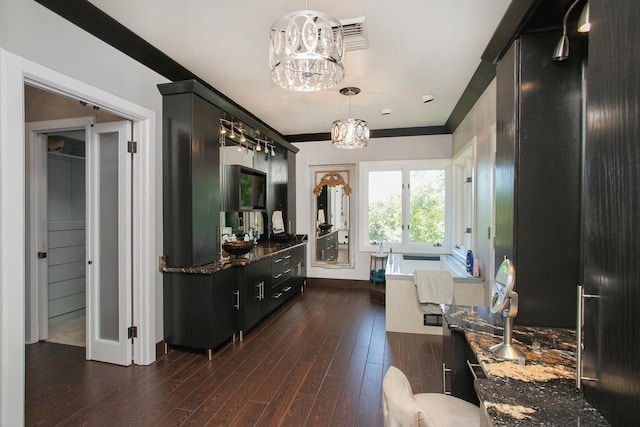 bathroom featuring an inviting chandelier, hardwood / wood-style flooring, and crown molding