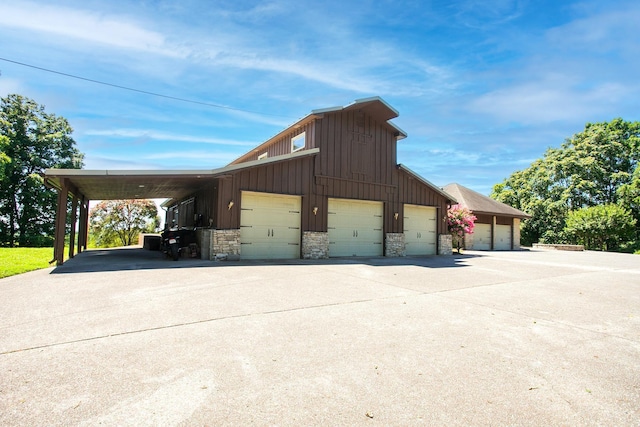 view of property exterior with a garage and an outbuilding