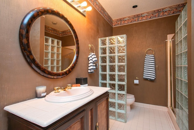 bathroom with tile patterned floors, toilet, a shower, a textured ceiling, and vanity