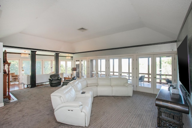 living room featuring french doors, lofted ceiling, and carpet flooring