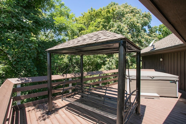 wooden terrace featuring a gazebo and a hot tub