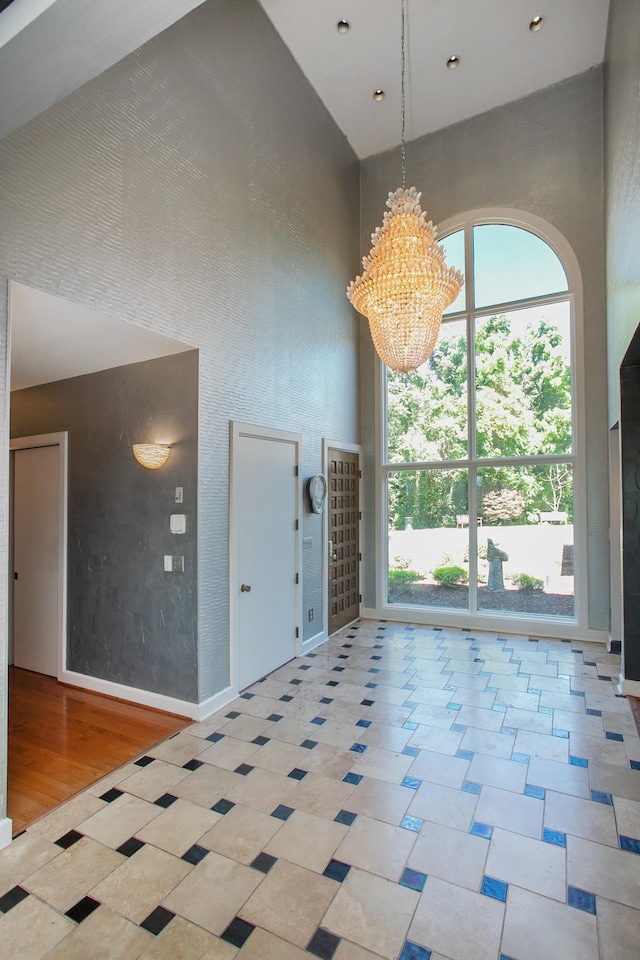 interior space with a high ceiling and an inviting chandelier