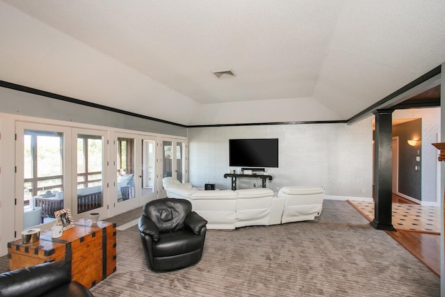 living room featuring a raised ceiling, lofted ceiling, and french doors