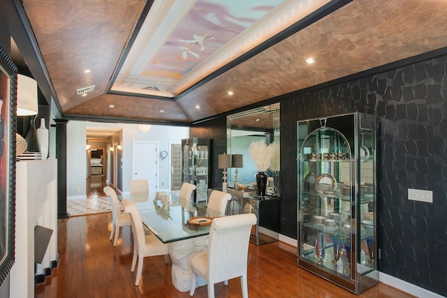 dining area with hardwood / wood-style floors and vaulted ceiling