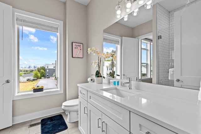 bathroom with vanity, tile patterned floors, and toilet