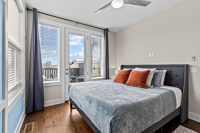 bedroom with ceiling fan, dark hardwood / wood-style floors, multiple windows, and access to outside