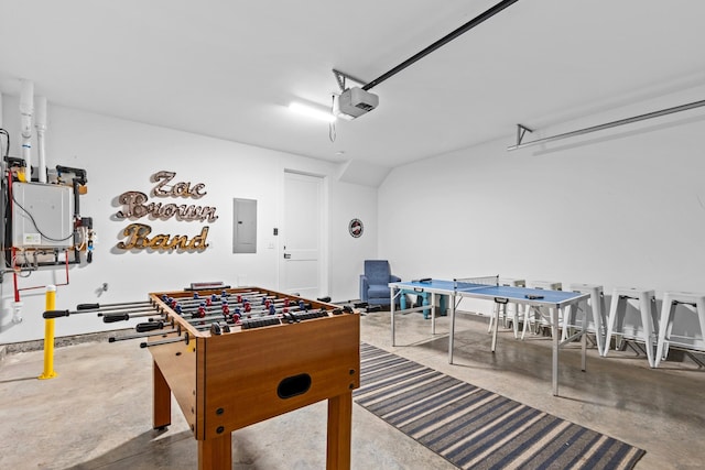 playroom featuring concrete flooring and electric panel