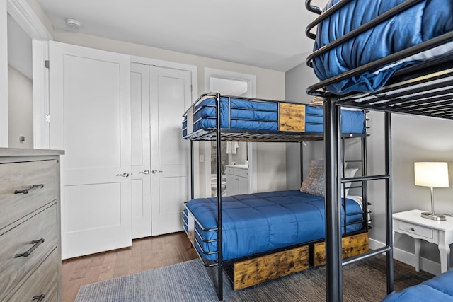 bedroom featuring dark wood-type flooring and a closet