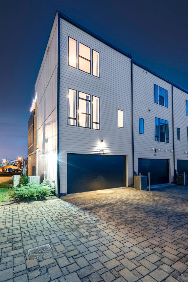 view of home's exterior featuring a garage and central AC