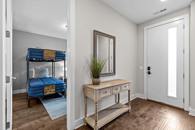 entryway with dark hardwood / wood-style flooring