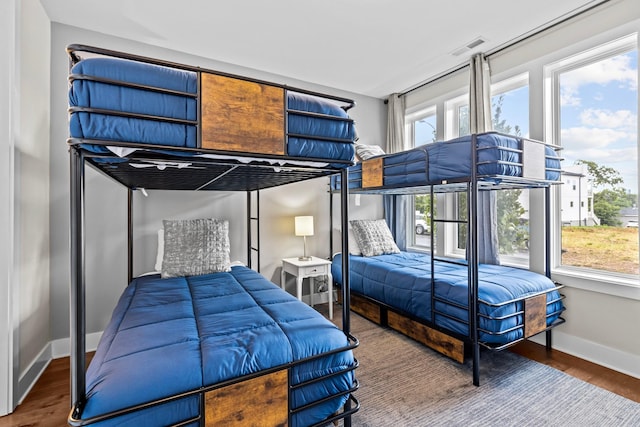 bedroom featuring multiple windows and hardwood / wood-style floors