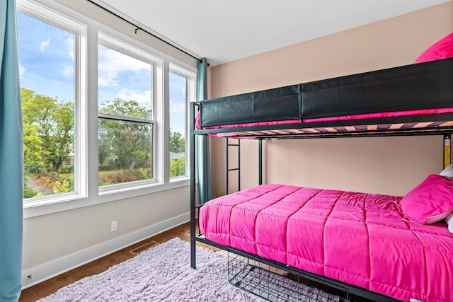 bedroom with dark wood-type flooring