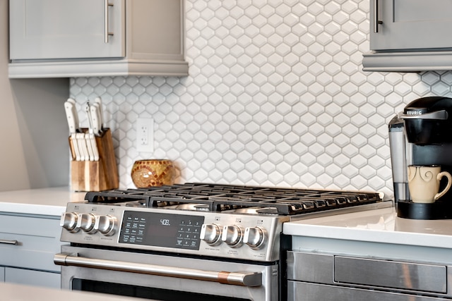 kitchen with backsplash and stainless steel range with gas cooktop