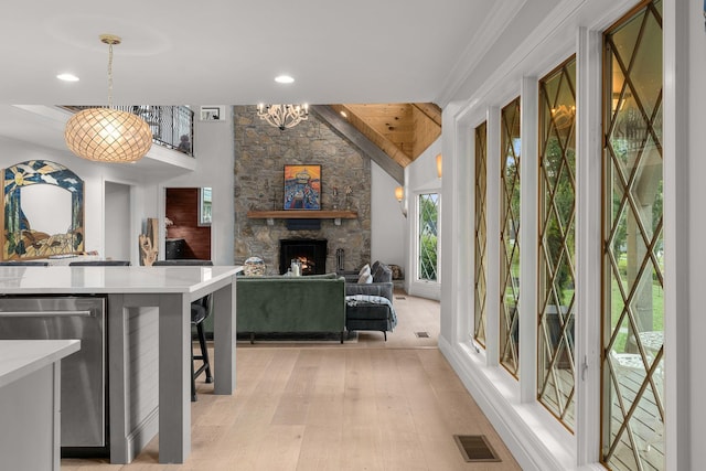 interior space featuring light hardwood / wood-style flooring, vaulted ceiling, and an inviting chandelier