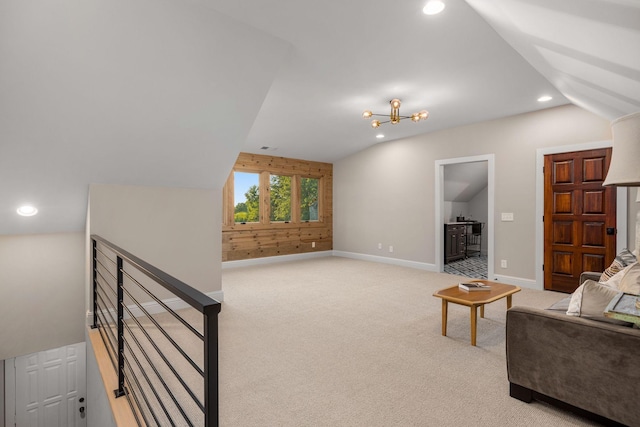 living room with light colored carpet, vaulted ceiling, and a notable chandelier