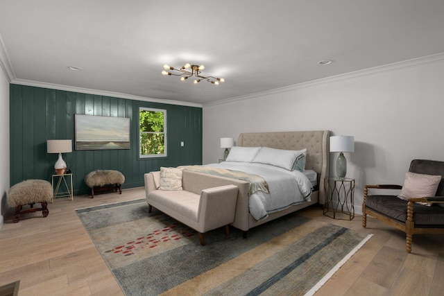 bedroom featuring hardwood / wood-style flooring, crown molding, and a notable chandelier