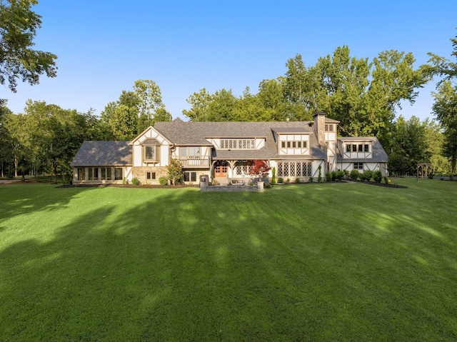 rear view of property featuring a yard