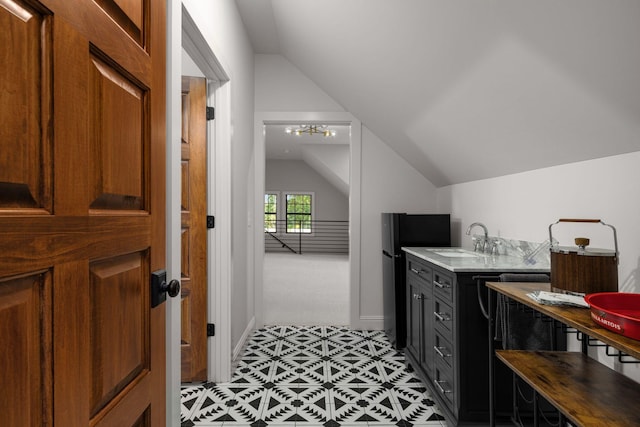 bathroom with vanity and lofted ceiling