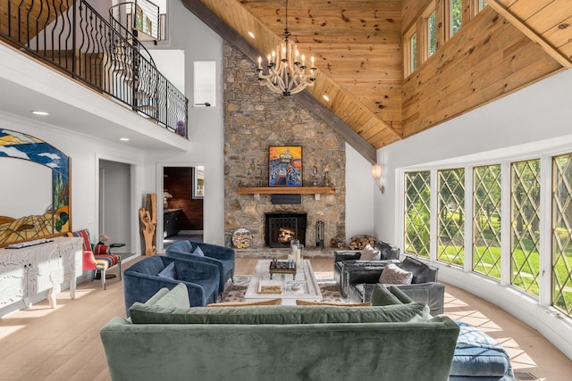 living room with a fireplace, high vaulted ceiling, wooden ceiling, and a notable chandelier