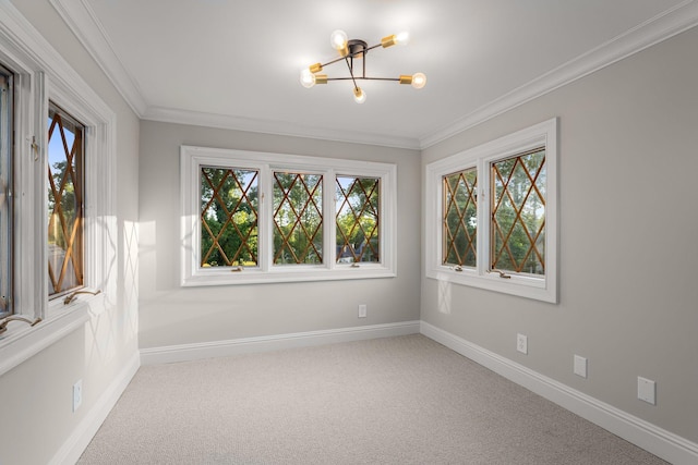 carpeted spare room with crown molding and a notable chandelier