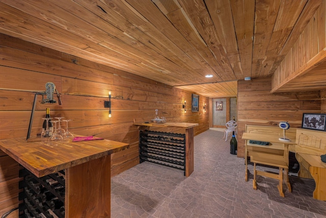 bar featuring butcher block countertops, wooden walls, and wood ceiling