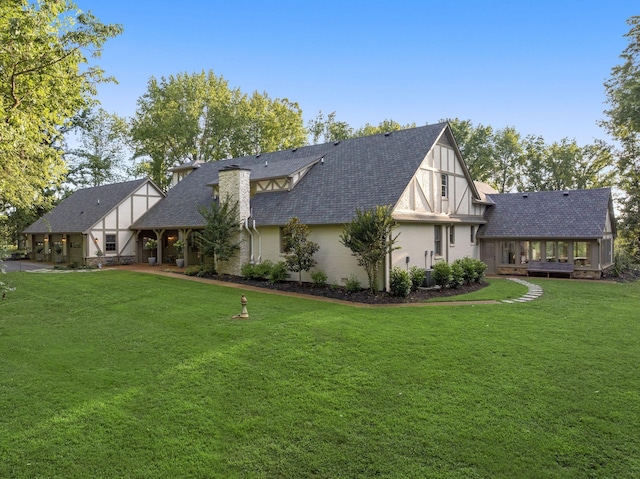 back of house featuring a yard