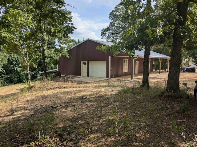 view of front of home with a garage and an outdoor structure