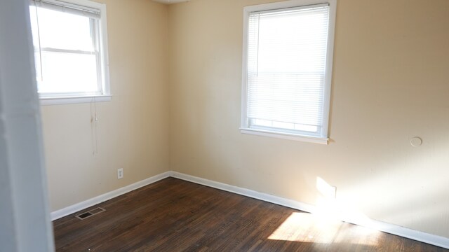 empty room with hardwood / wood-style flooring