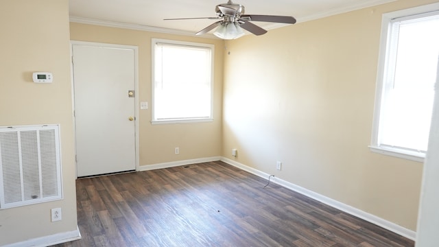 spare room with plenty of natural light, ceiling fan, dark hardwood / wood-style flooring, and ornamental molding