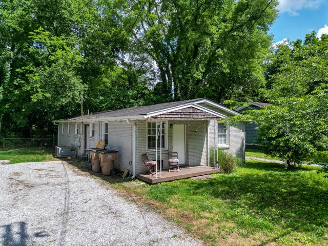 view of front of home featuring a deck and a front yard