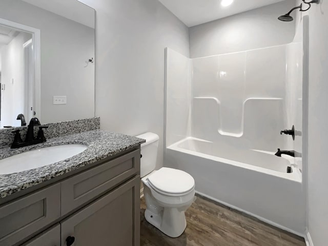 full bathroom featuring toilet, bathtub / shower combination, wood-type flooring, and vanity