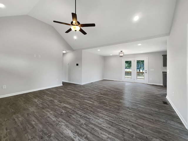 unfurnished living room featuring vaulted ceiling, dark wood-type flooring, and ceiling fan