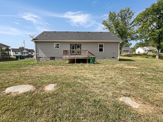 rear view of property with a lawn and a wooden deck