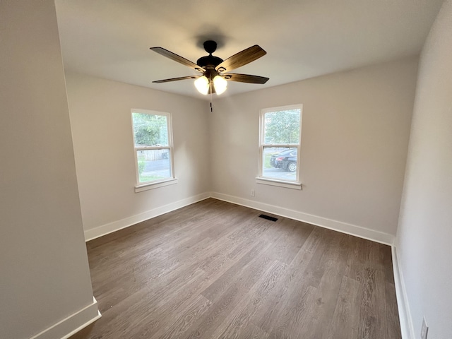 unfurnished room with wood-type flooring, ceiling fan, and plenty of natural light