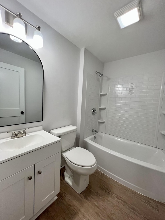 full bathroom with hardwood / wood-style flooring, vanity, toilet, and tiled shower / bath combo